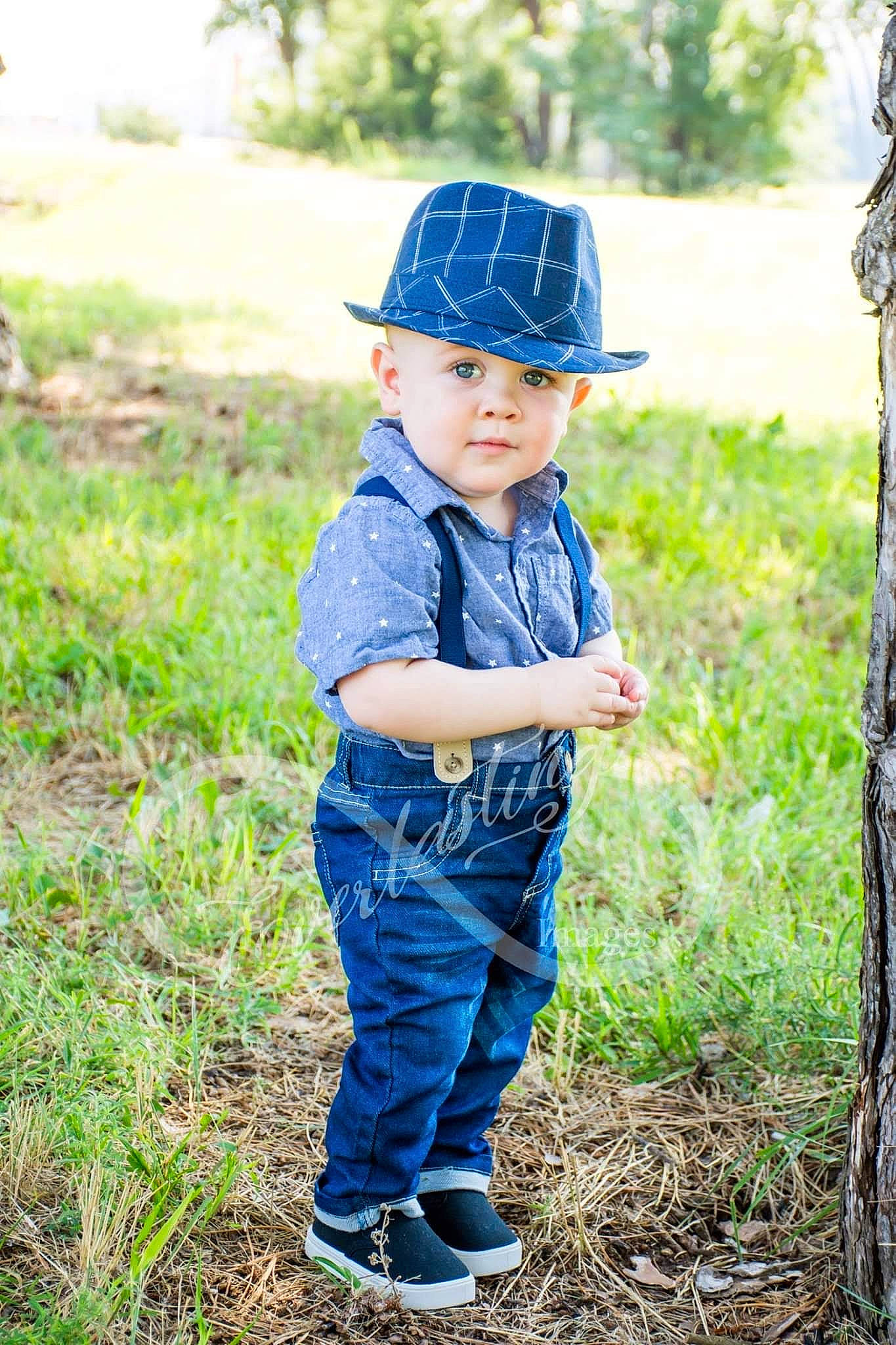 Marcas is registered to the contest to win money with this photo: baby, cap, child, child_model, denim, grass, hat, headgear, male, person, photo_shoot, photograph, photography, plant, portrait, portrait_photography, smile, soil, toddler, tree