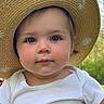 baby, child, closeup, cute, daisies, face, greenery, hat, headwear, innocence, nature, outdoor, person, portrait, straw_hat, summer, sunlight, toddler, white_shirt, young_child