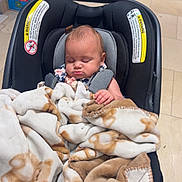 Josefina joined the competition — help win amazing prizes! baby, car_seat, blanket, sleeping, child, indoor, store, shopping, teddy_bear_pattern, clothing, person, infant, comfort, resting, seatbelt, floor, box, shelf, shopping_cart, tiled_floor
