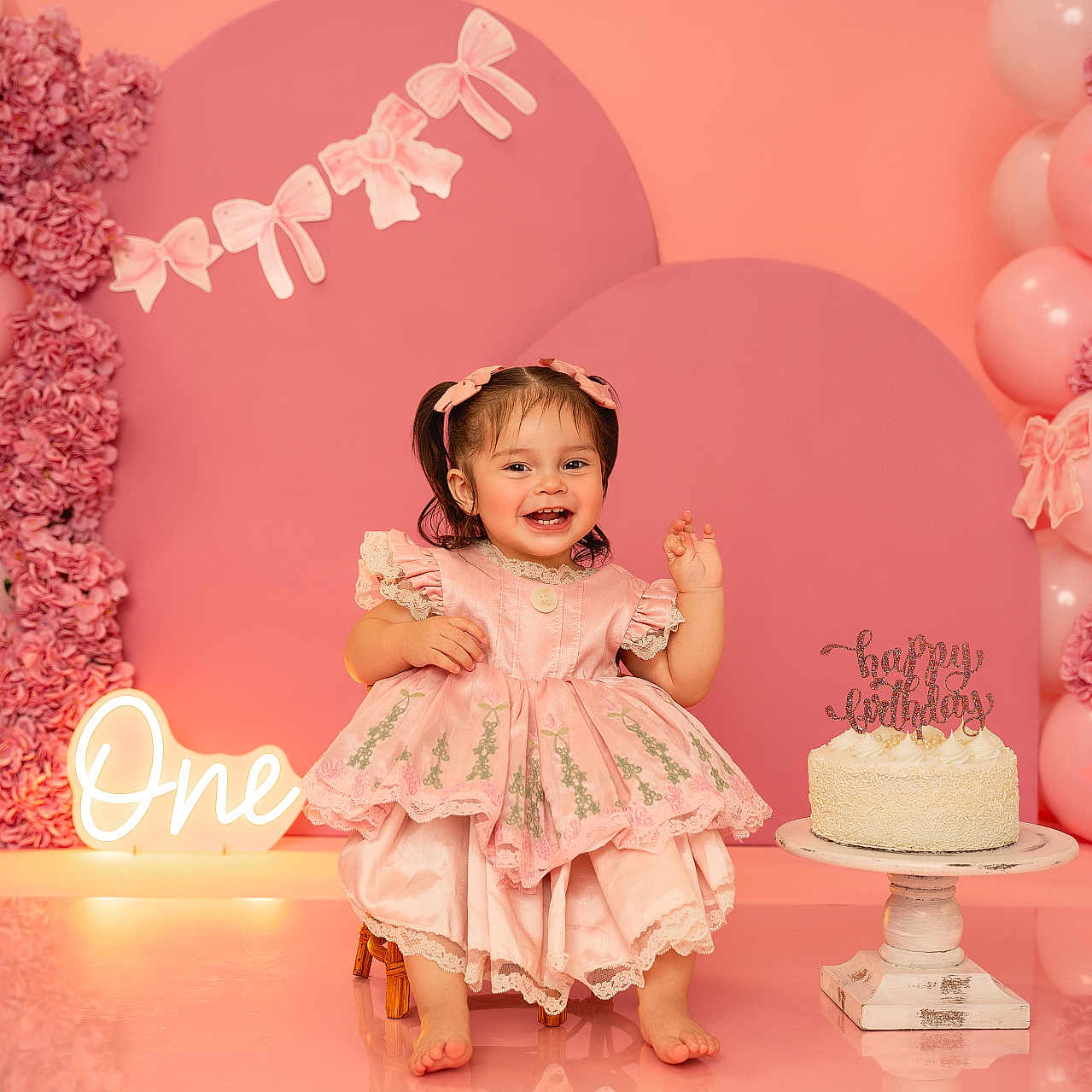 Neveah joined the competition — help win amazing prizes! baby, balloons, birthday, cake, celebration, child, cute, decorations, dress, flowers, footwearless, girl, happy, indoor, party, pigtails, pink, portrait, sitting, smiling