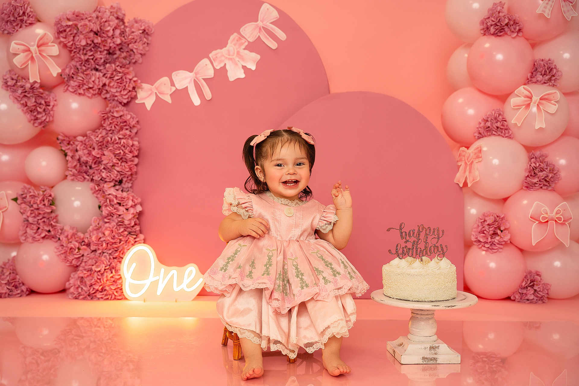 Neveah joined the competition — help win amazing prizes! baby, child, birthday, cake, pink, dress, balloons, flowers, celebration, smiling, portrait, cute, decorations, happy, sitting, indoor, party, girl, pigtails, footwearless