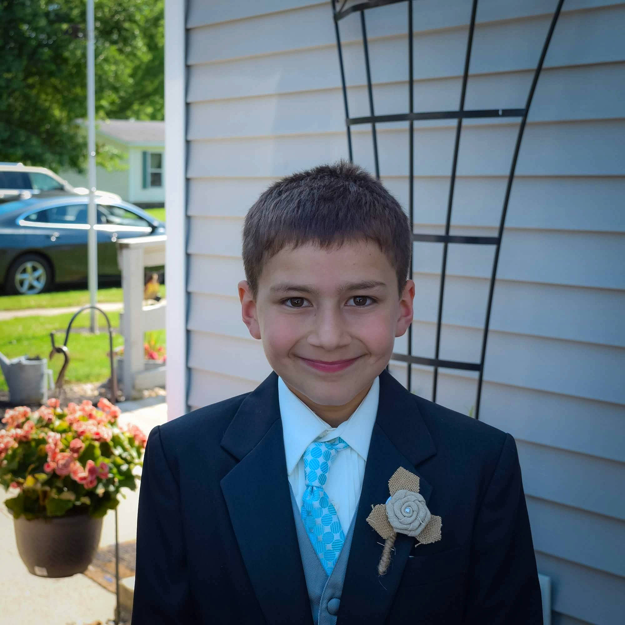 Aidan is registered to the contest to win money with this photo: blazer, businessperson, ceremony, event, fashion_accessory, flower, forehead, formal_wear, hair, hairstyle, joy, official, outerwear, person, plant, prom, smile, suit, tie, tuxedo