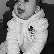 Kayron participe au concours pour gagner de l'argent avec cette photo : baby, black_and_white, child, closeup, couch, cozy, cute, eyelashes, fuzzy, hands, high_contrast, hoodie, indoor, infant, laughing, mickey_mouse, portrait, sitting, smile, socks