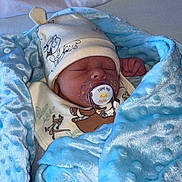 Kayron participe au concours pour gagner de l'argent avec cette photo : baby, newborn, pacifier, blanket, blue_blanket, hat, sleeping, cute, infant, wrapped, soft_texture, cozy, clothing, face, child, peaceful, indoors, resting, baby_boy, comfort