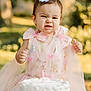 baby, birthday_cake, bow, butterfly, cake, celebration, child, cute, face_expression, festive, happy, nature, outdoor, party, person, pink_dress, portrait, smile, table, toddler