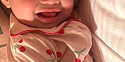 Amara joined the competition — help win amazing prizes! adult, baby, bed, blanket, cherry_pattern, child, closeup, cozy, cute, face, family, hand, happy, indoor, lying_down, pajamas, person, portrait, skin, smiling