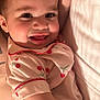 adult, baby, bed, blanket, cherry_pattern, child, closeup, cozy, cute, face, family, hand, happy, indoor, lying_down, pajamas, person, portrait, skin, smiling