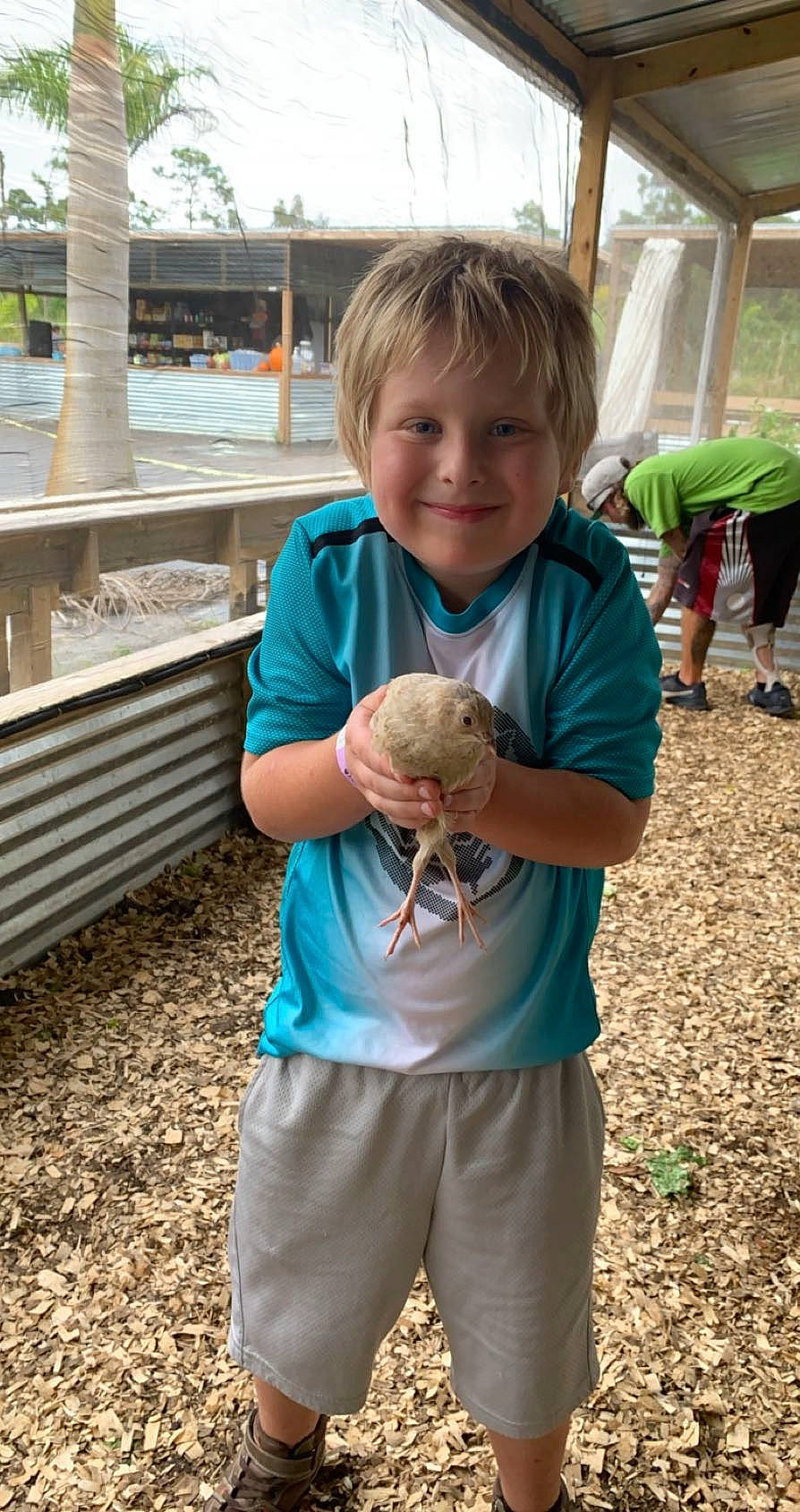 Kodi is registered to the contest to win money with this photo: child, finger, fun, gesture, grass, green, happy, joy, leisure, people_in_nature, person, plant, shorts, sky, sleeve, smile, soil, t_shirt, thumb, toddler
