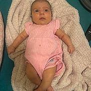 Addison joined the competition — help win amazing prizes! baby, infant, pink_onesie, blanket, fluffy, lying_down, curious, wide_eyes, indoor, soft_texture, cozy, child, cute, person, skin, head, legs, arms, fabric, bed
