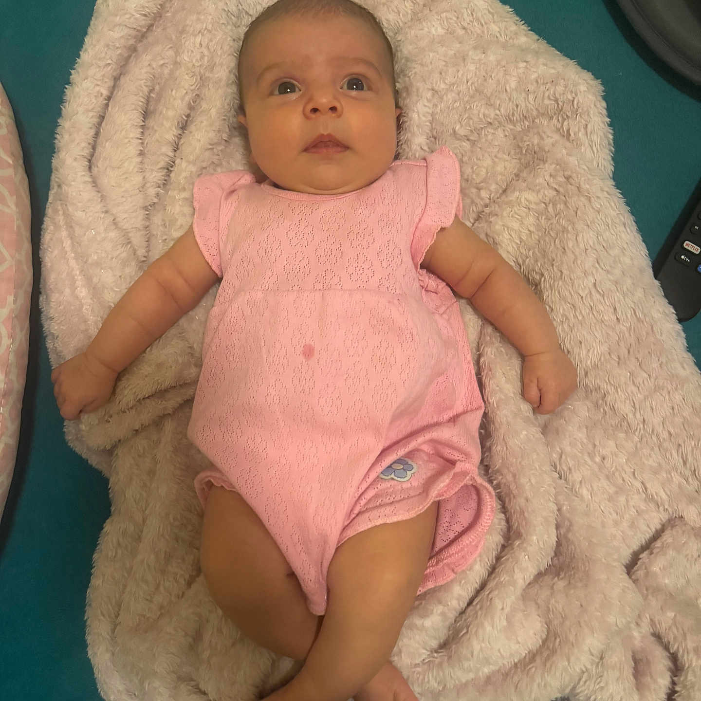 Addison joined the competition — help win amazing prizes! baby, infant, pink_onesie, blanket, fluffy, lying_down, curious, wide_eyes, indoor, soft_texture, cozy, child, cute, person, skin, head, legs, arms, fabric, bed