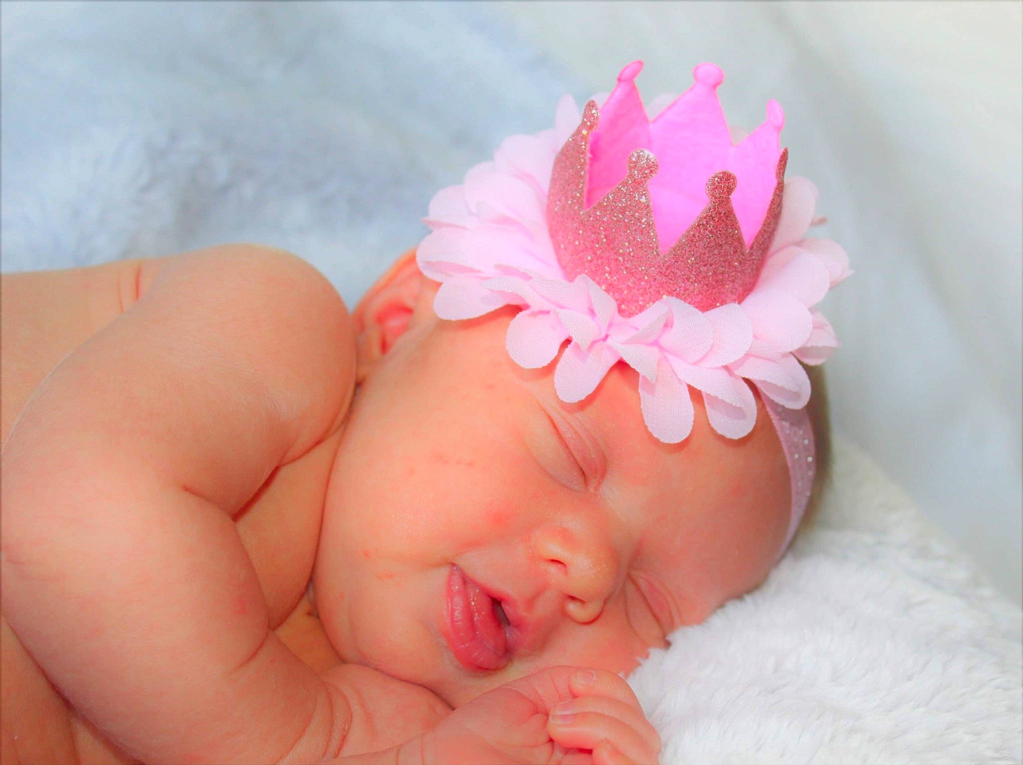 Shayla joined the competition — help win amazing prizes! baby, baby_sleeping, baby_toddler_clothing, child, crown, fashion_accessory, finger, flower, hair_accessory, hand, headband, headgear, headpiece, nail, person, petal, pink, plant, product, skin