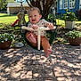 Freya is registered to the contest to win money with this photo: baby, swing, outdoor, child, happy, smiling, tree, sunlight, plants, pot, backyard, house, grass, pavement, playground, daylight, footwear, clothing, person, nature
