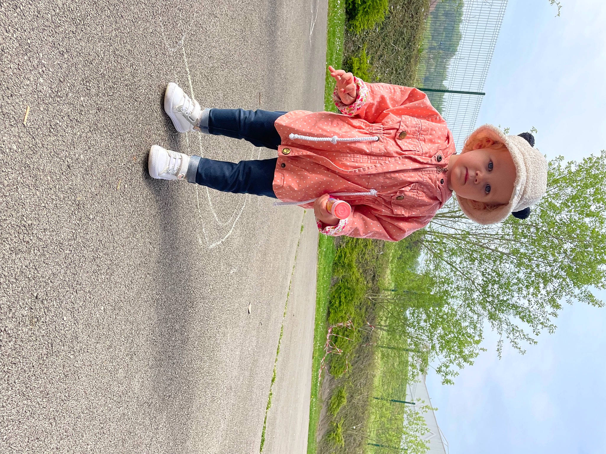 Ellie participe au concours pour gagner de l'argent avec cette photo : asphalt, carmine, cloud, foot, fun, grass, happy, headwear, human_leg, jeans, leisure, people_in_nature, person, plant, road_surface, sidewalk, sky, smile, toddler, tree