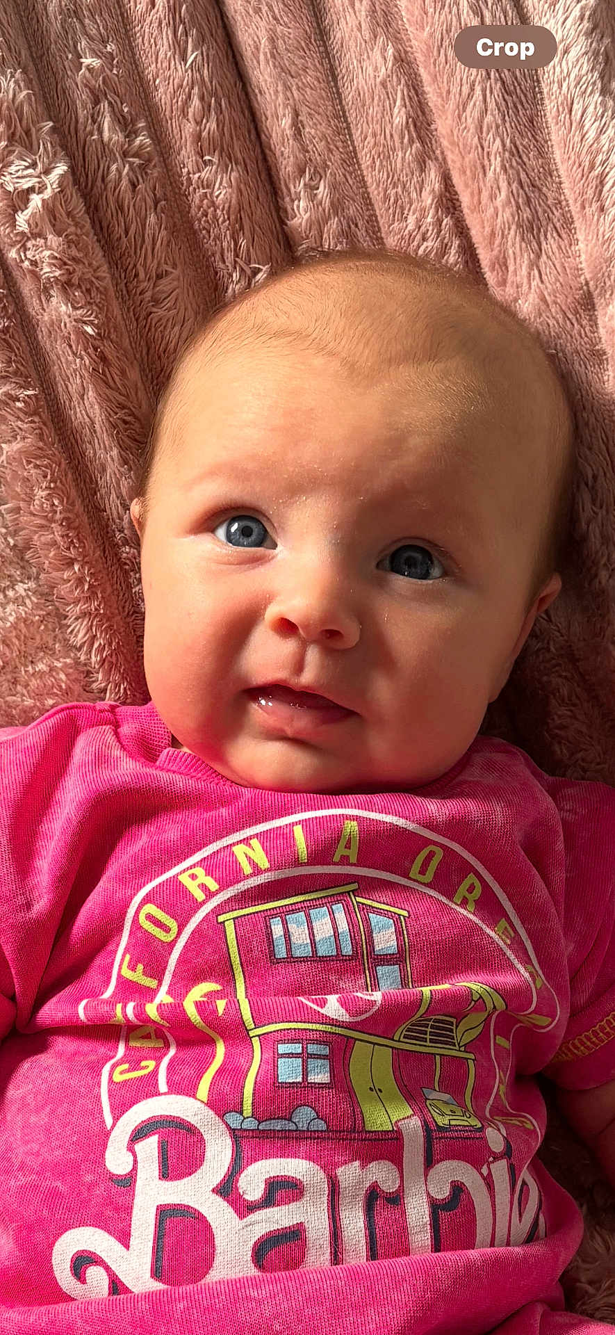 Aubriella joined the competition — help win amazing prizes! baby, infant, child, face, blue_eyes, pink_clothing, barbie, blanket, soft_texture, portrait, cute, expression, lying_down, indoors, close_up, skin, head, person, young_child, toddler