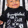 baby, infant, child, smiling, portrait, lying_down, black_clothing, onesie, striped_blanket, stuffed_toy, blue_toy, indoor, close_up, face, head, eyes, happy, baby_clothing, grandpa_message, photography