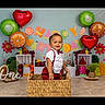 baby, child, portrait, smiling, birthday, fruit, orange, kiwi, strawberry, watermelon, basket, woven_basket, indoor, celebration, colorful, decorations, plants, tropical, standing, studio_photography