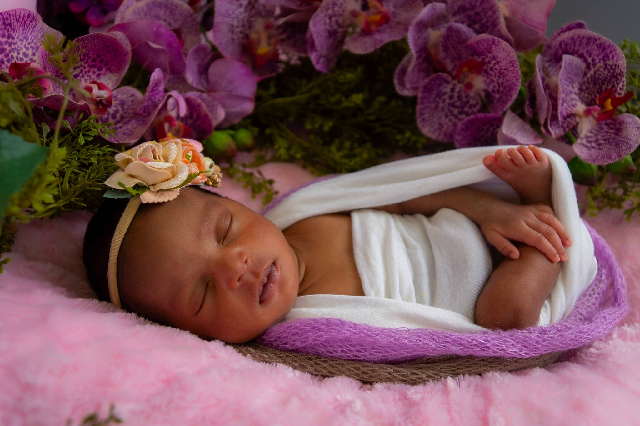 Laila joined the competition — help win amazing prizes! baby, baby_sleeping, baby_toddler_clothing, comfort, cut_flowers, flower, flower_arranging, grass, happy, headgear, leaf, linens, person, petal, pink, plant, purple, skin, textile, toddler