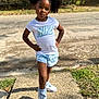 afro, bows, child, confident, cute, fashion, girl, grass, hair, nike, outdoor, playful, posing, shadow, shoes, shorts, sidewalk, sunlight, tshirt, young