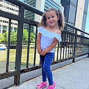 Mia joined the competition — help win amazing prizes! architecture, boat, building, child, city, clothing, face, female, footwear, girl, head, jeans, pants, person, sandal, shoe, standing, transportation, urban, vehicle