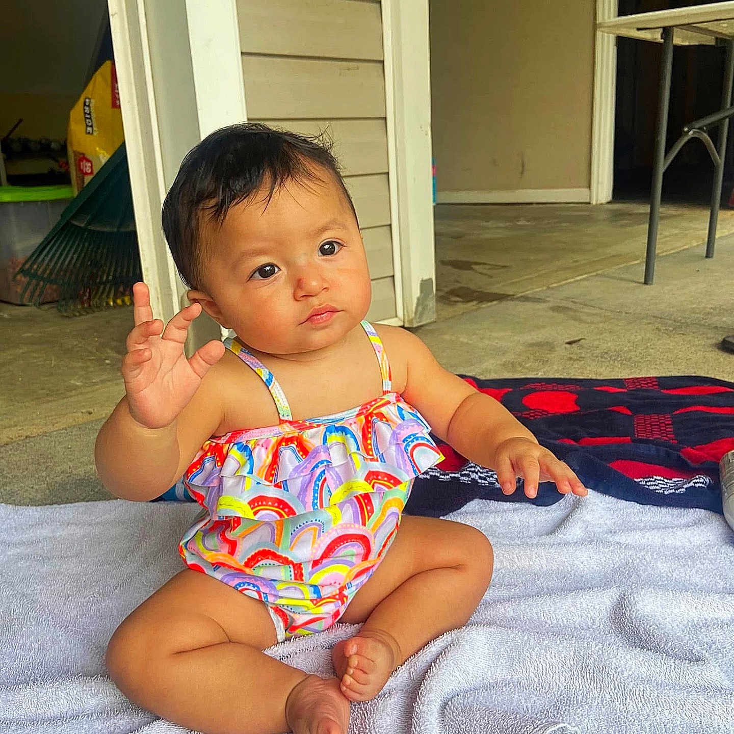 Christina is registered to the contest to win money with this photo: baby, child, colorful_clothing, curious, doorway, expression, face, floor, foot, hair, hand_gesture, household_items, indoor, leg, person, sitting, skin, swimsuit, toddler, towel