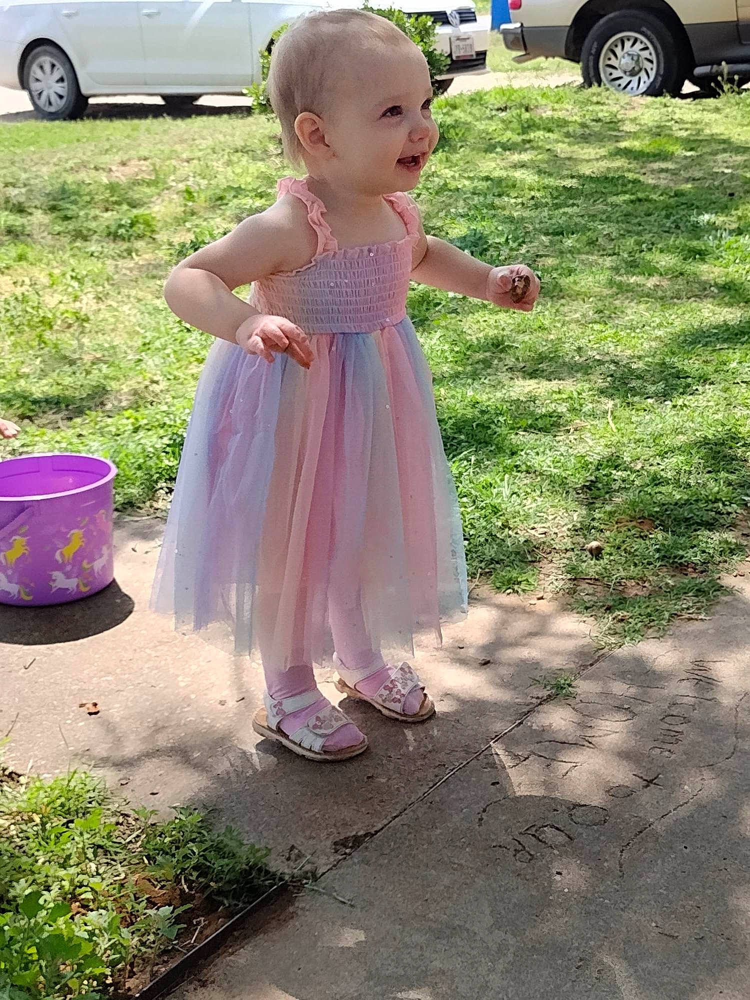 Dorothy is registered to the contest to win money with this photo: asphalt, automotive_tire, baby, car, child, event, family_car, fun, grass, lawn, person, pink, plant, recreation, sandal, summer, tire, toddler, vehicle, vehicle_door