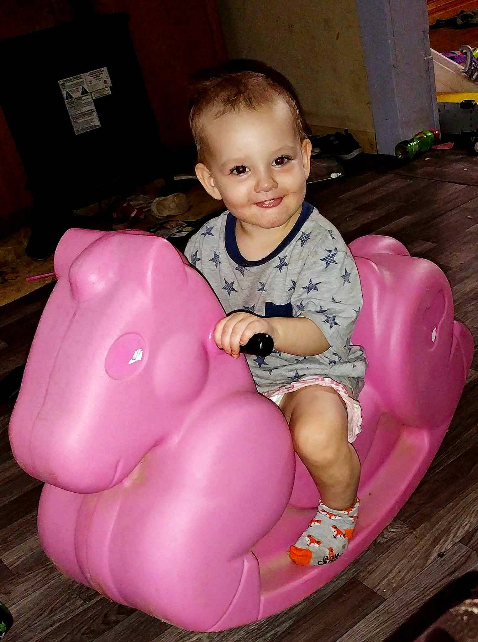 Dorothy is registered to the contest to win money with this photo: baby, baby_toddler_clothing, beauty, child, comfort, event, face, facial_expression, flooring, fun, happy, head, human_body, joy, lap, magenta, person, pink, sitting, skin