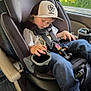 Hunter is registered to the contest to win money with this photo: child, toddler, car_seat, sleeping, toy_trucks, cap, jeans, seatbelt, car_interior, window, daylight, relaxing, peaceful, hand, clothing, seat, vehicle, transportation, kid, nap