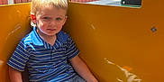 Hunter joined the competition — help win amazing prizes! child, boy, blonde_hair, blue_shirt, striped_shirt, jeans, sneakers, yellow_wall, window, building, red_wall, white_wall, sitting, indoor, sunlight, shadow, contemplative, casual_clothing, young, portrait
