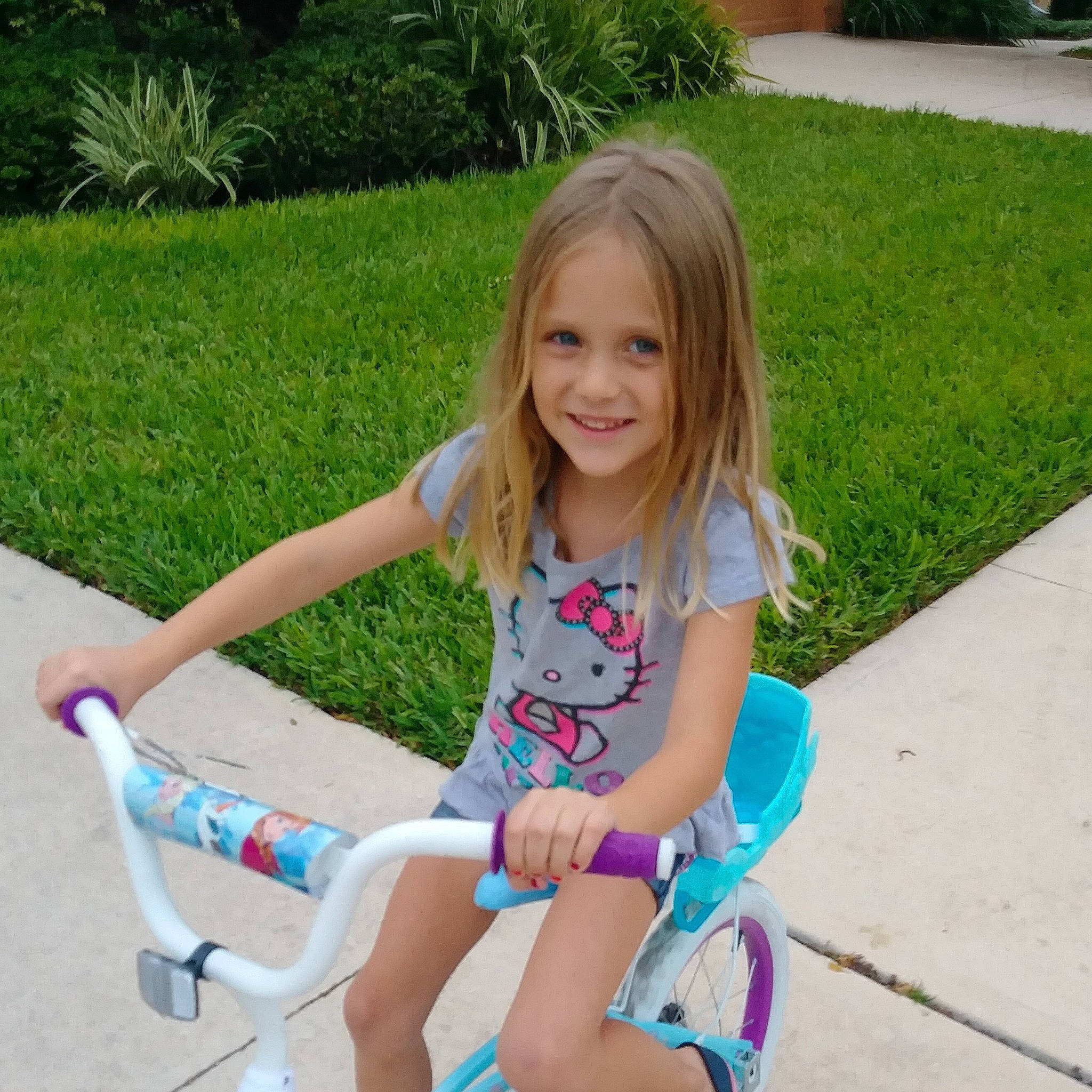 M'Kenzie is registered to the contest to win money with this photo: arm, blond, child, day, fun, girl, grass, joy, leg, person, pink, play, product, shoe, shorts, sitting, smile, summer, toddler, vacation