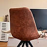 cat, chair, furniture, living_room, pet, curious, paw, brown, white, indoor, wood_floor, television, cabinet, relaxing, playful, cozy, home, peek, animal, domestic