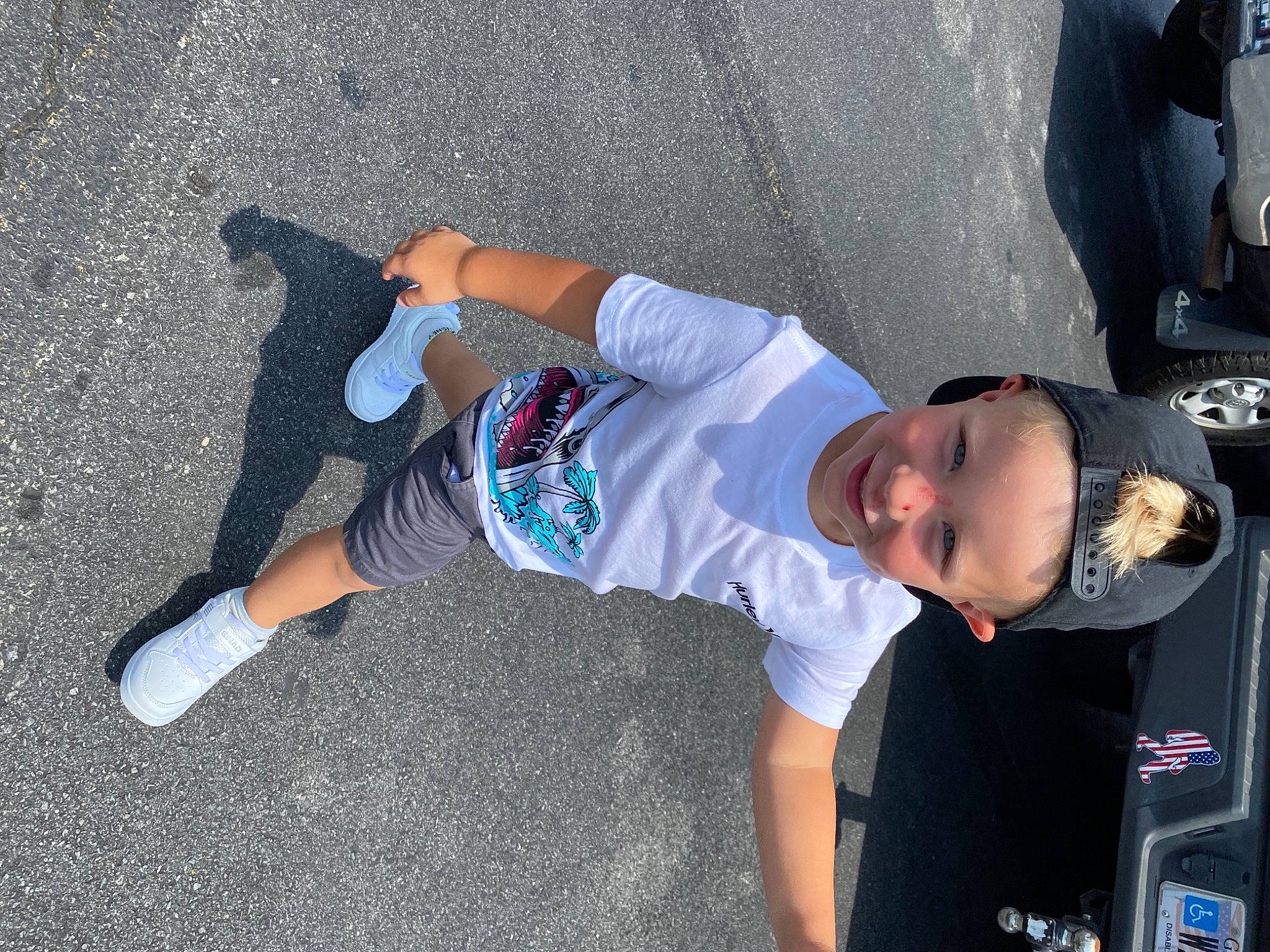 Kolson joined the competition — help win amazing prizes! asphalt, automotive_exterior, automotive_tire, bumper, electric_blue, hat, headwear, joint, joy, knee, motor_vehicle, person, shoe, shorts, smile, sneakers, t_shirt, tire, toddler, vehicle