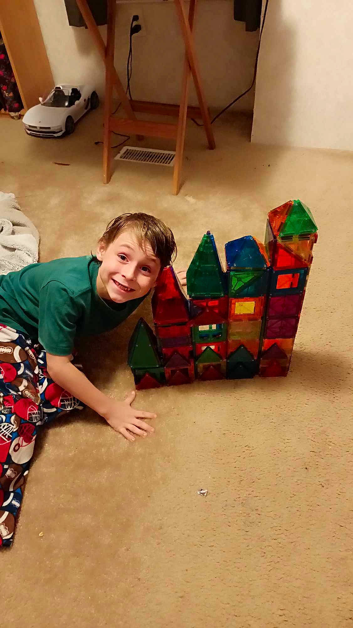 Sebastian joined the competition — help win amazing prizes! box, cardboard, child, christmas, event, floor, flooring, fun, happy, holiday, joy, laugh, leisure, person, play, recreation, room, sitting, smile, t_shirt