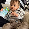 Kaylan a rejoint le concours — aidez-le/la à gagner de superbes lots ! baby, blanket, blue_eyes, casual_clothing, child, closeup, feeding_pouch, hand, indoors, messy_hair, mickey_mouse_patch, onesie, patterned_curtain, portrait, sitting, sofa, stain, striped_socks, thoughtful_expression, toddler