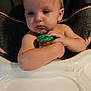 baby, child, high_chair, food_jar, infant, cute, portrait, indoor, person, skin, face, hand, feeding, baby_food, expression, seat, young_child, holding, close_up, toddlers