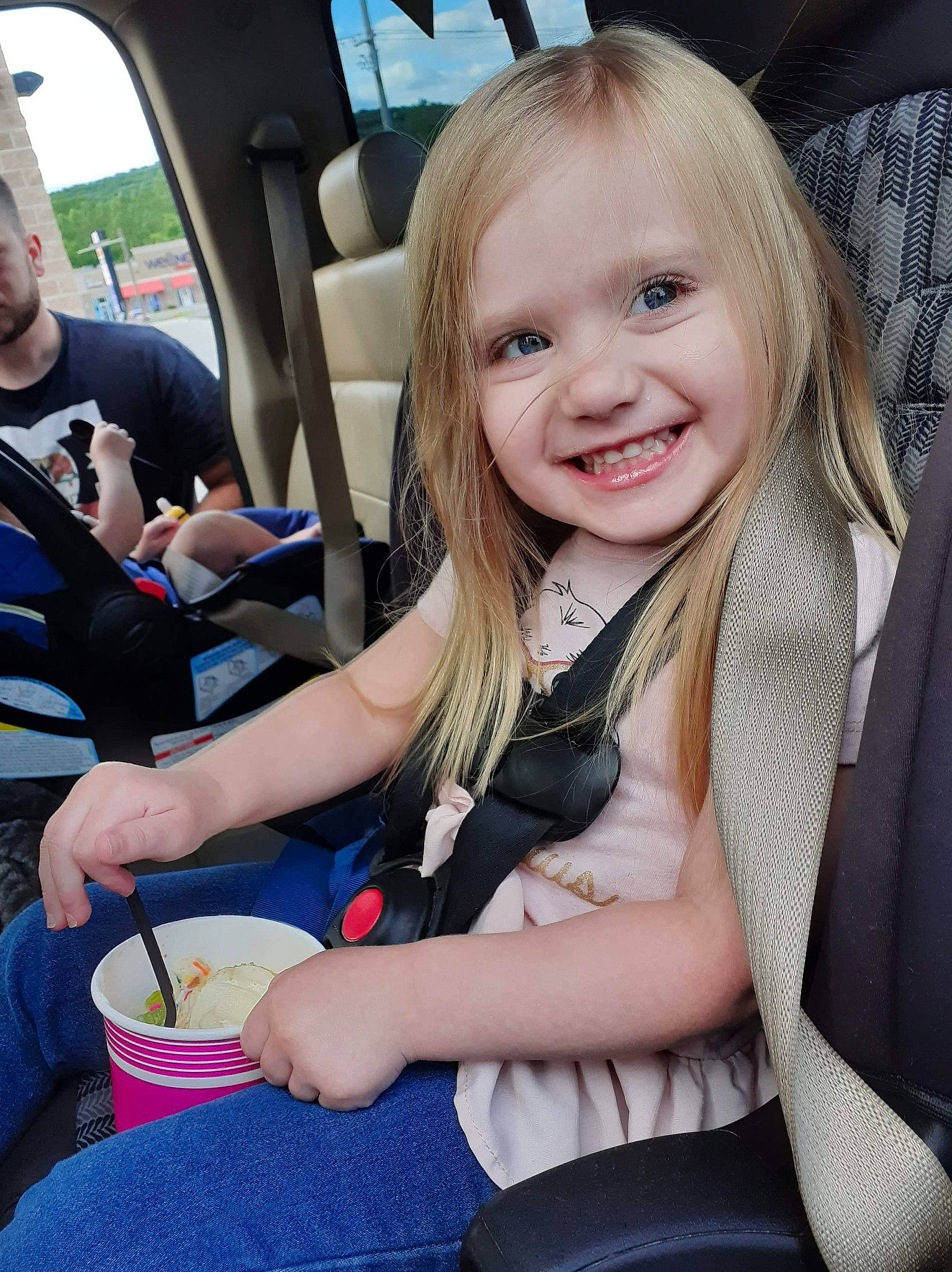 Maelie is registered to the contest to win money with this photo: baby_in_car_seat, blond, car, car_seat, child, fun, joy, luxury_vehicle, person, sitting, smile, toddler, vacation