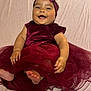 apparel, baby, child, cute, dress, fabric, feet, hands, happy, headband, indoors, infant, lying_down, maroon, person, portrait, skin, smiling, soft_texture, toddler