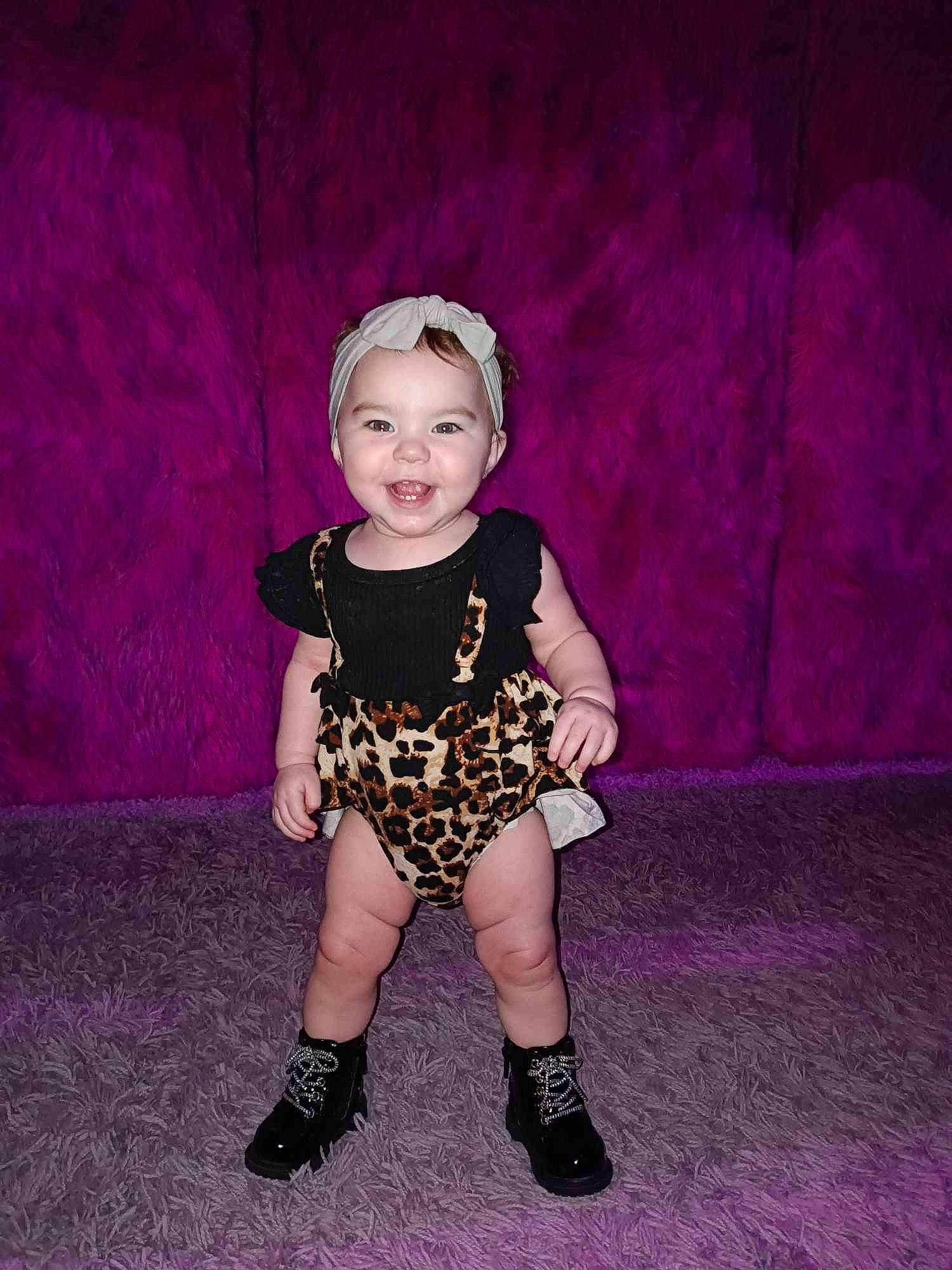 Journee is registered to the contest to win money with this photo: baby, baby_toddler_clothing, child, electric_blue, fashion_design, flash_photography, headwear, human_body, human_leg, jewellery, joy, knee, leg, magenta, pattern, person, pink, purple, sitting, sleeve