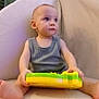 Noah joined the competition — help win amazing prizes! baby, child, indoor, toy, chair, sitting, curious, soft_furniture, window_blinds, casual_clothing, barefoot, young_child, playful, portrait, infant, home, comfort, looking_away, person, furniture