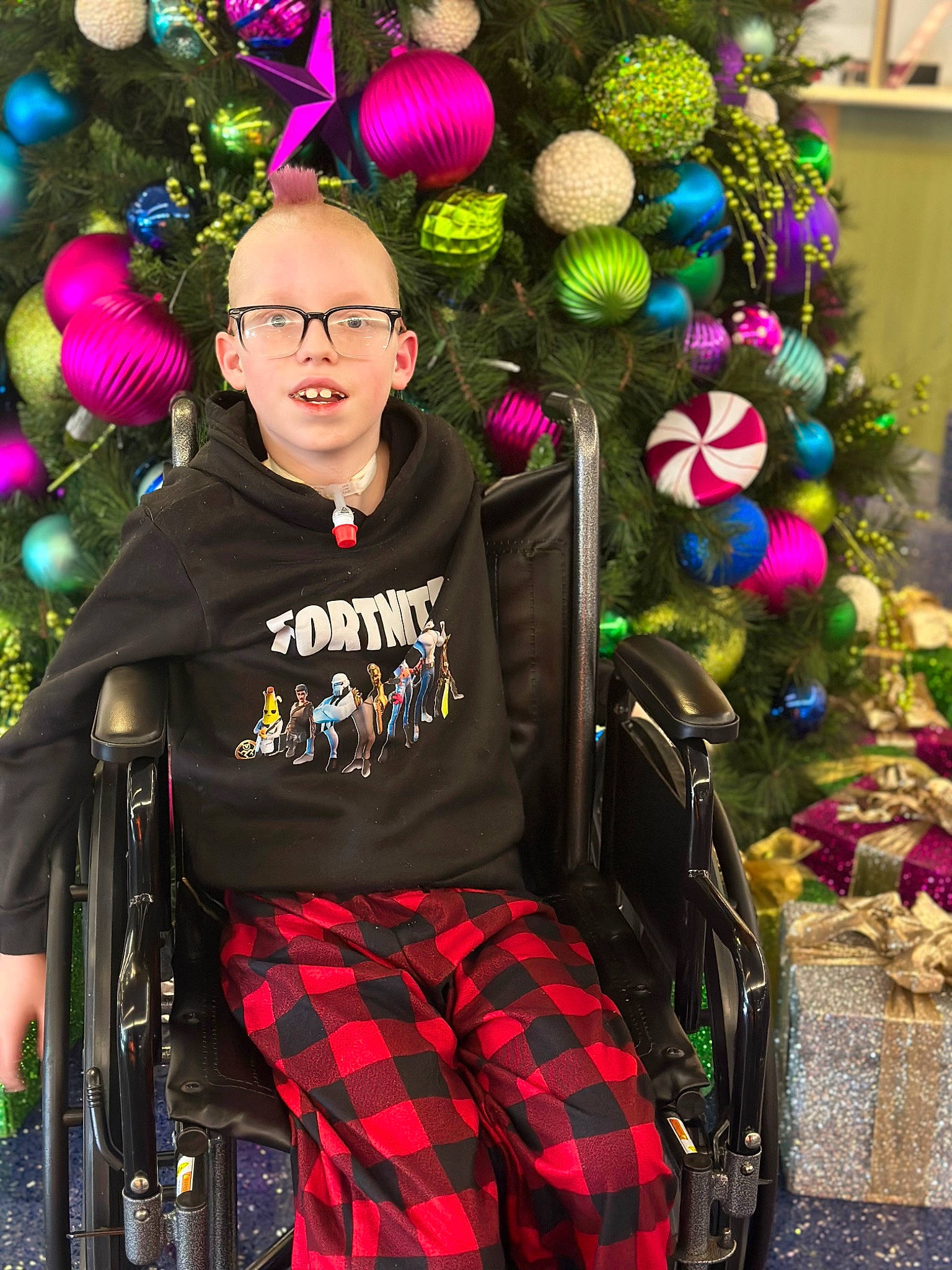 Carson joined the competition — help win amazing prizes! chair, christmas, christmas_decoration, christmas_eve, christmas_ornament, christmas_tree, event, fun, green, holiday, holiday_ornament, magenta, ornament, pattern, person, plaid, plant, sitting, tartan, tree