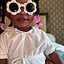 Amani joined the competition — help win amazing prizes! accessories, baby, blouse, bodypart, clothing, earring, face, glasses, goggles, happy, head, jewelry, person, photography, portrait, purple, sitting, smile, sunglasses, t_shirt