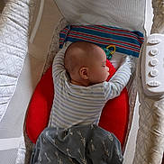 Avalon is registered to the contest to win money with this photo: baby, sleeping, bassinet, blanket, pillow, toy, infant, sleep, cozy, resting, child, bed, fabric, comfort, indoor, person, peaceful, soft_lighting, striped_clothing, blanket_pattern