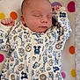 baby, sleeping, infant, onesie, animal_print, blanket, polka_dot, cute, peaceful, child, newborn, soft, cozy, resting, portrait, face, hand, zipped, colorful, indoors