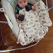 Avalon joined the competition — help win amazing prizes! animal_print, baby, baby_accessory, baby_bedding, baby_rocker, blanket, child, clothing, comfort, cozy, cute, face, floor, indoor, infant, mittens, person, resting, seat, wood_floor