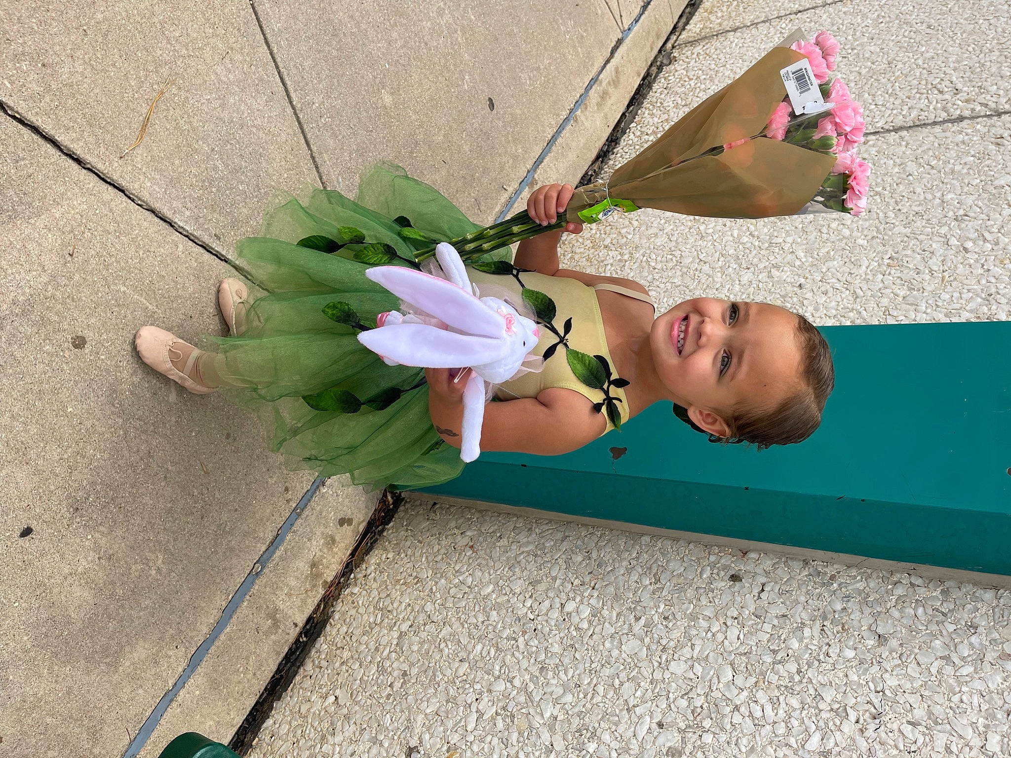 Amora is registered to the contest to win money with this photo: asphalt, child, concrete, costume, cut_flowers, fashion_accessory, feather, floral_design, grass, human_leg, joy, magenta, party_supply, person, petal, plant, road_surface, sidewalk, smile, toddler