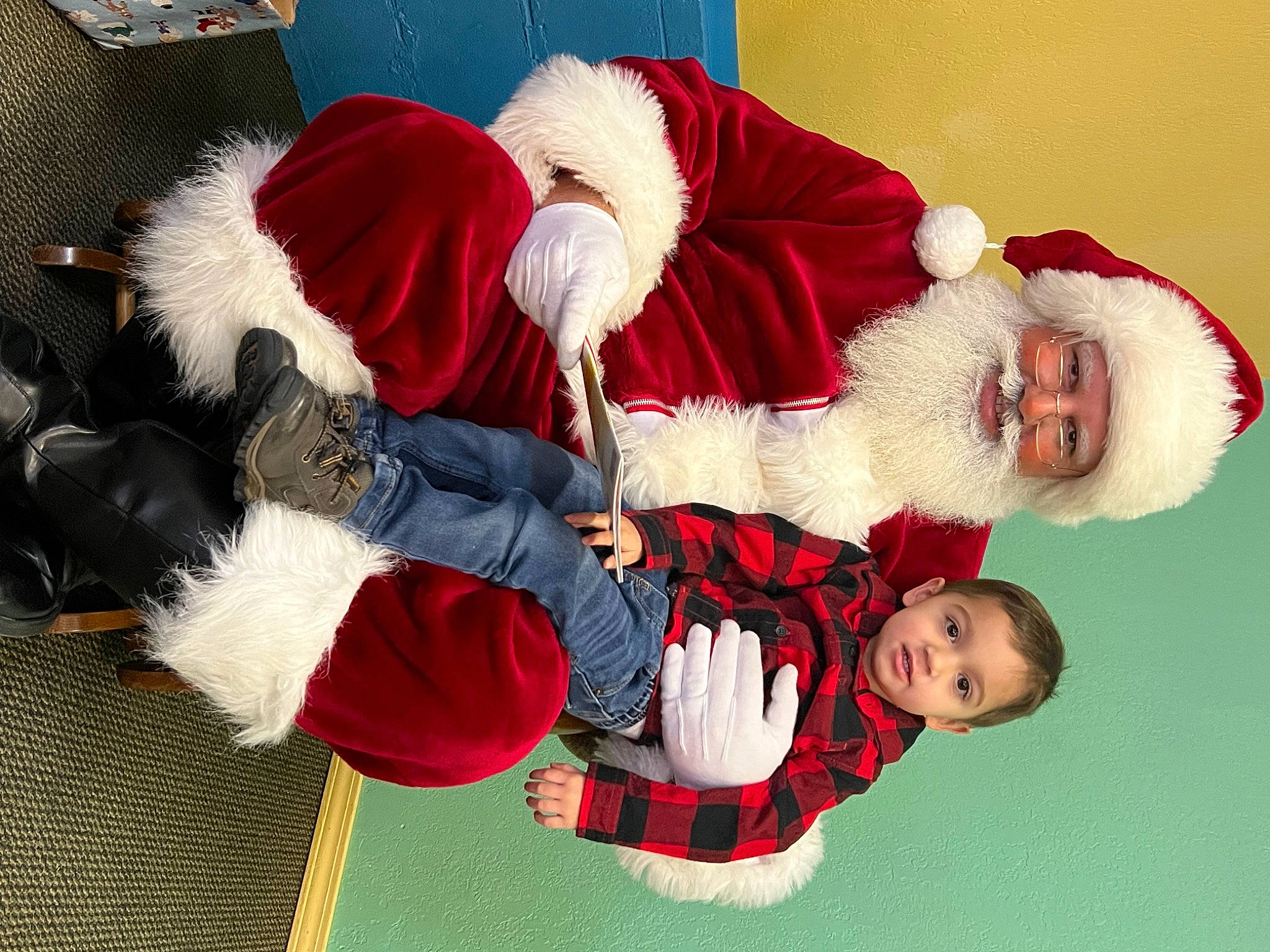 Arlo is registered to the contest to win money with this photo: baby, carmine, christmas, christmas_eve, event, fictional_character, fun, fur, happy, headwear, holiday, human_leg, knee, lap, person, red, santa_claus, smile, sock, thigh