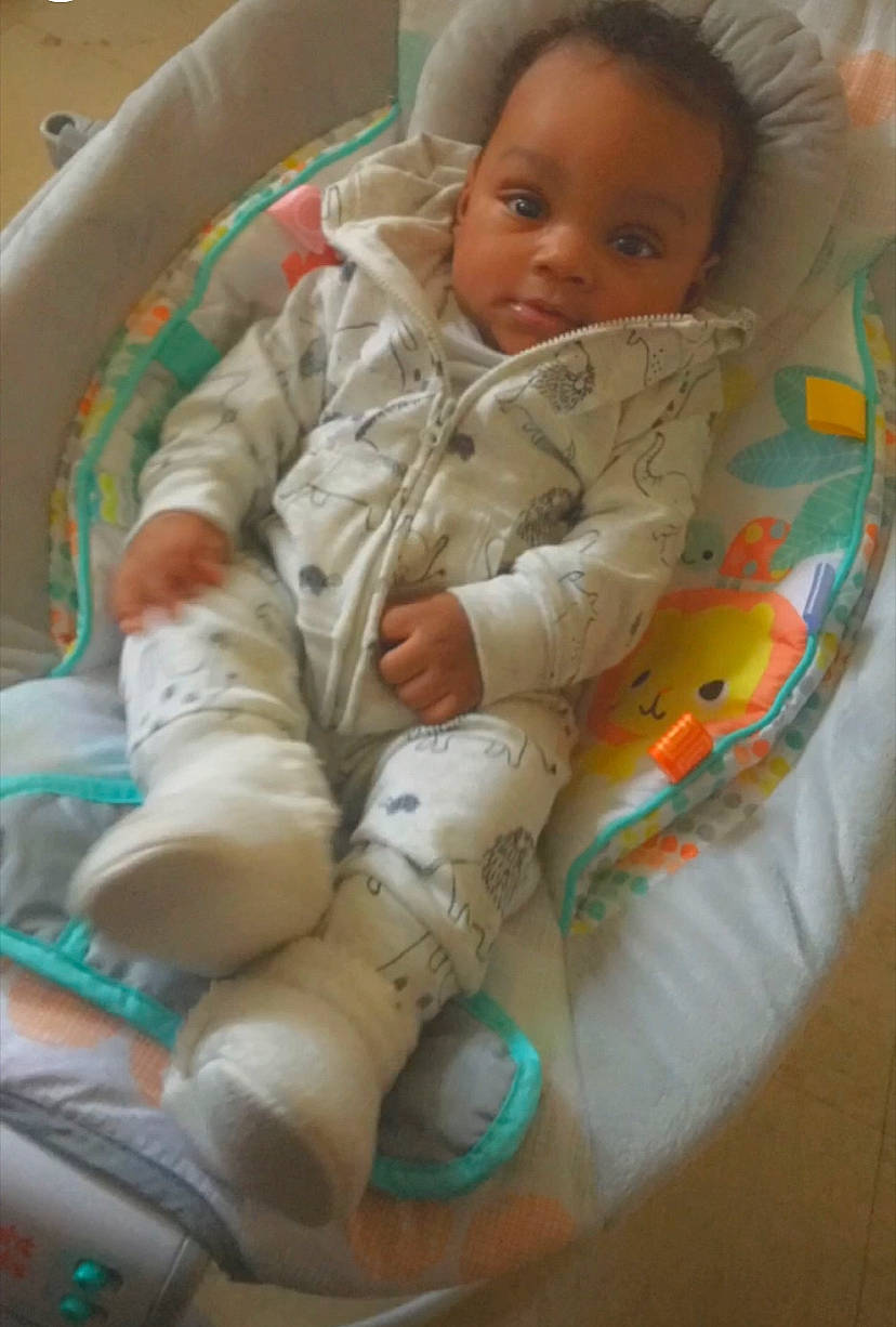 Zaire is registered to the contest to win money with this photo: baby, baby_products, baby_safety, baby_sleeping, baby_toddler_clothing, cheek, child, comfort, face, flooring, head, linens, pattern, person, room, sitting, skin, sleeve, textile, thumb