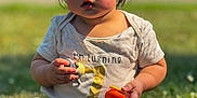 Jaxon joined the competition — help win amazing prizes! baby, child, grass, outdoor, sunlight, toy, shirt, first_birthday, sitting, cute, young_child, nature, summer, one_year_old, happy, portrait, barefoot, greenery, daytime, playful