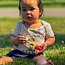 baby, child, grass, outdoor, sunlight, toy, shirt, first_birthday, sitting, cute, young_child, nature, summer, one_year_old, happy, portrait, barefoot, greenery, daytime, playful