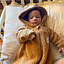 baby, blanket, clothing, crib, cushion, face, furniture, hat, head, homedecor, hood, hoodie, infantbed, knitwear, person, photography, portrait, quilt, sweater, sweatshirt