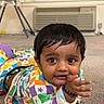 Rishaan is registered to the contest to win money with this photo: air_conditioner, baby, black_hair, bracelet, carpet, child, colorful_clothing, curious, expression, eyes, face, floor, hand, indoor, lying_down, patterned_outfit, playful, room, toddler, window